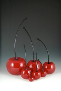 7 red glass cherries with black stems