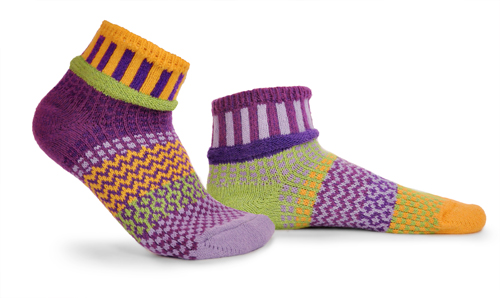 mismatched socks with lots of purple, lavender, yellow, and some light green.
