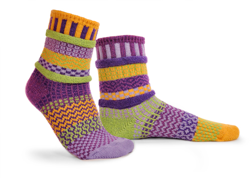 mismatched socks with lots of yellow, purple, some lavender,and light green.