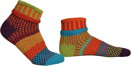 Mismatched socks with lots of orange, some turquoise, some light green, some yellow.